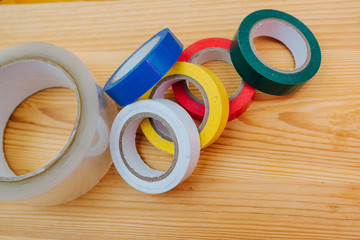Color rolls of gaffer tape, duct tape, on a wood background