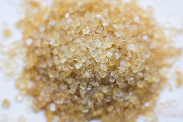 Crystals of Sugar.Brown cane sugar isolated on white background.Top view. Flat lay.