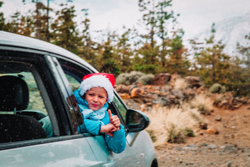 christmas car travel- happy kid loves travel in winter