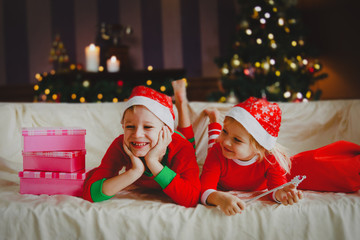 Kids enjoy christmas celebration, getting presents at home