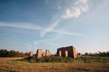 old soviet factory ruins on  a field 