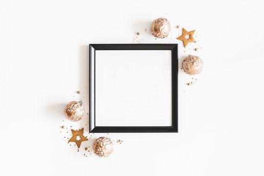 Christmas composition. Photo frame, golden decorations on white background. Christmas, winter, new year concept. Flat lay, top view, copy space