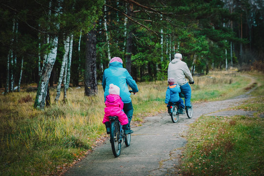 senior grandparents with kids riding bikes in nature