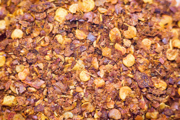 Dried chili flakes and seeds isolated on white background.Pile crushed red cayenne pepper,top view.