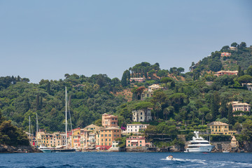 Fototapeta na wymiar Buildings on the cliffs overlooking the beautiful harbour at Portofino on the Ligurian coast, Italy