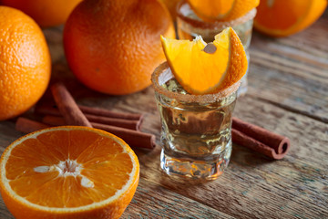 Tequila, orange slices and cinnamon sticks.