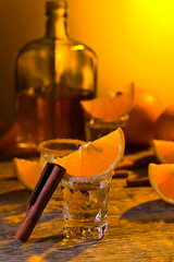 Tequila, orange slices and cinnamon sticks.