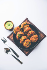 Crispy Corn Tikki, pakora/pakoda or pattice also known as cutlet. served with green chutney. Selective focus