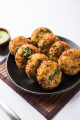 Crispy Corn Tikki, pakora/pakoda or pattice also known as cutlet. served with green chutney. Selective focus