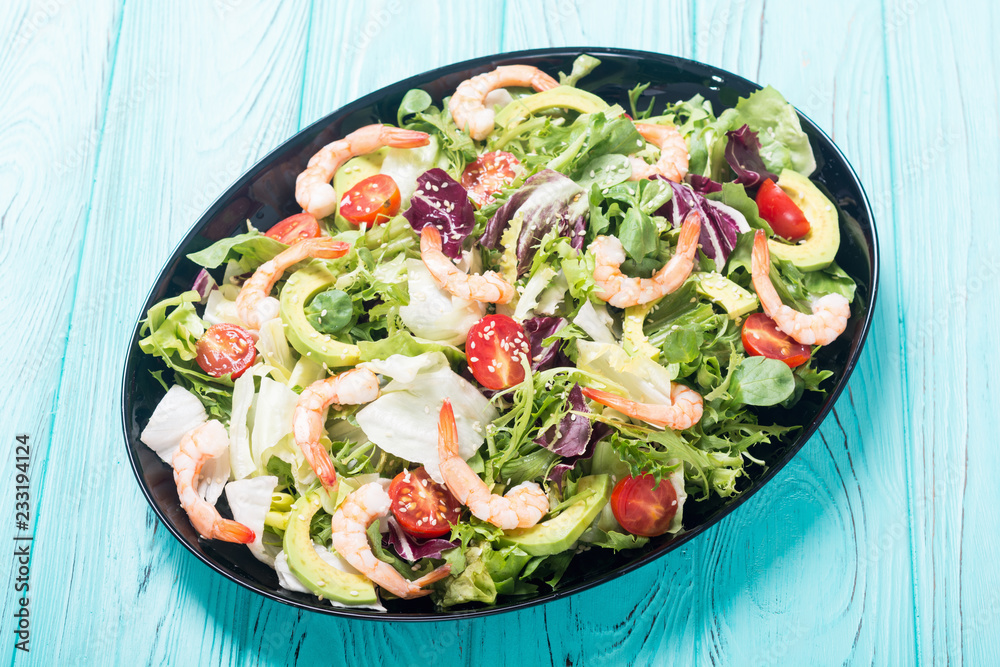 Wall mural Mix of salad with shrimps , avocado and cherry tomatoes . Healthy food background