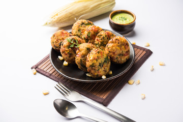 Crispy Corn Tikki, pakora/pakoda or pattice also known as cutlet. served with green chutney. Selective focus