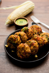Crispy Corn Tikki, pakora/pakoda or pattice also known as cutlet. served with green chutney. Selective focus