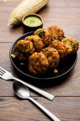 Crispy Corn Tikki, pakora/pakoda or pattice also known as cutlet. served with green chutney. Selective focus