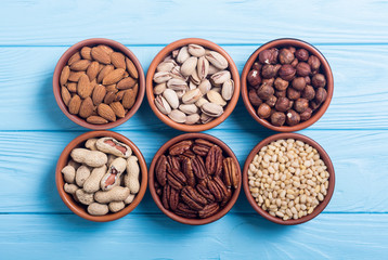 Mix of nuts : Pistachios, almonds , walnuts , pine nut , hazelnuts and cashew . Snack in bowl backgrond