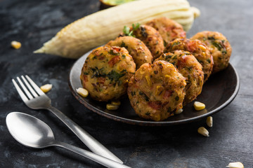 Crispy Corn Tikki, pakora/pakoda or pattice also known as cutlet. served with green chutney. Selective focus