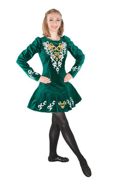 Beautiful young woman in Irish dance green dress isolated
