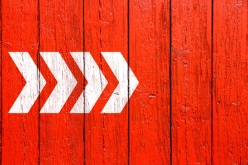 White directional arrow signs pointing direction painted on a red wood wall signboard texture background. - 233195919