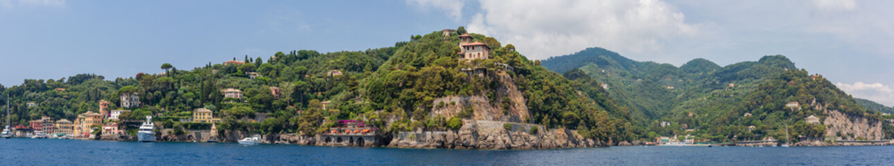 Fototapeta na wymiar Panoramic view encompassing the entrance to Portofino harbour and the neighbouring town of Paraggi, Ligurian coast, Italy