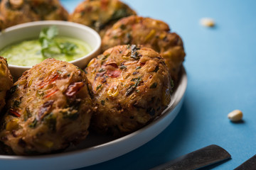 Crispy Corn Tikki, pakora/pakoda or pattice also known as cutlet. served with green chutney. Selective focus
