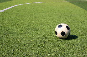 Fototapeta na wymiar Football on artificial turf. It is for green background in a stadium