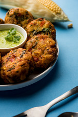 Crispy Corn Tikki, pakora/pakoda or pattice also known as cutlet. served with green chutney. Selective focus