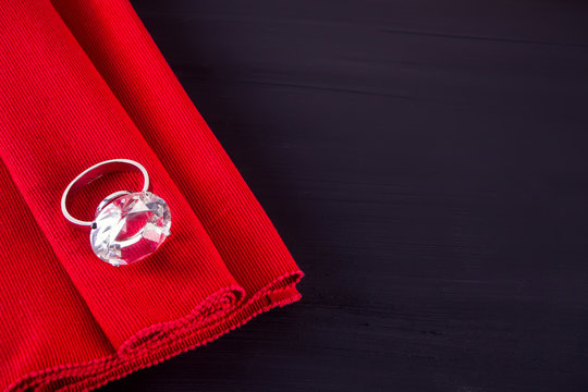 Big Diamond Ring On The Red Table Napkin.