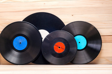 Vinyl record in front of a collection of albums, vintage process. Copy space for text