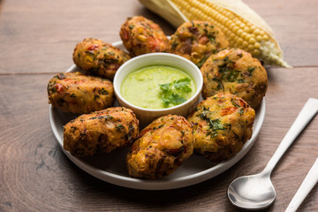 Crispy Corn Tikki, pakora/pakoda or pattice also known as cutlet. served with green chutney. Selective focus