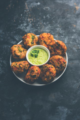 Crispy Corn Tikki, pakora/pakoda or pattice also known as cutlet. served with green chutney. Selective focus