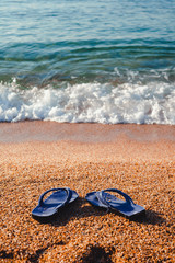 Fototapeta na wymiar blue Slippers on the beach Lloret de Mar