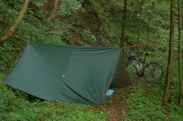 Bicycle touring camping at forest with a tent