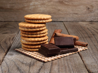 Cookies and chocolate slices on a wooden surface.