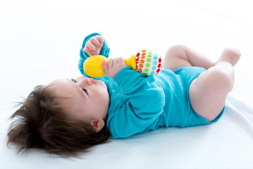 Little baby boy playing with his toys