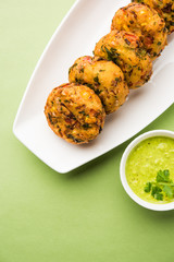 Crispy Corn Tikki, pakora/pakoda or pattice also known as cutlet. served with green chutney. Selective focus