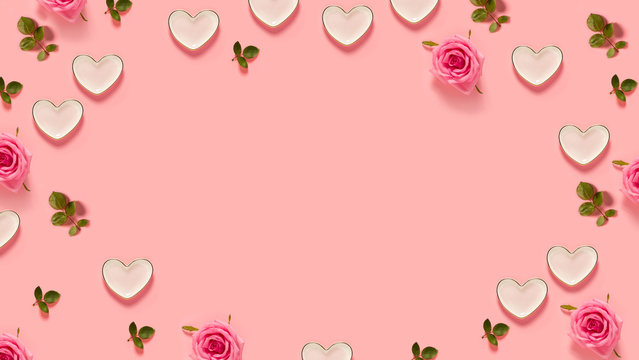 Fototapeta Pink roses and hearts on a pastel pink background
