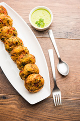 Crispy Corn Tikki, pakora/pakoda or pattice also known as cutlet. served with green chutney. Selective focus