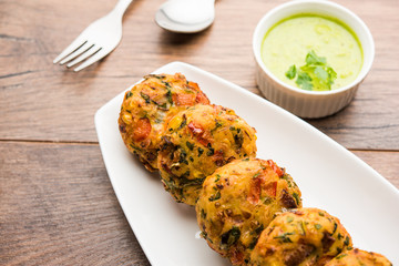 Crispy Corn Tikki, pakora/pakoda or pattice also known as cutlet. served with green chutney. Selective focus