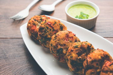 Crispy Corn Tikki, pakora/pakoda or pattice also known as cutlet. served with green chutney. Selective focus