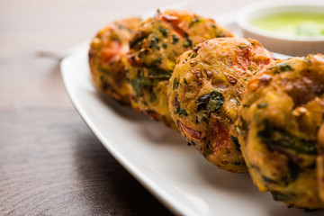 Crispy Corn Tikki, pakora/pakoda or pattice also known as cutlet. served with green chutney. Selective focus