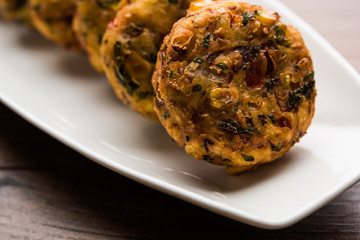 Crispy Corn Tikki, pakora/pakoda or pattice also known as cutlet. served with green chutney. Selective focus