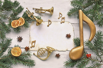 Christmas tree with music note , paper , trumpet on wooden background  - obrazy, fototapety, plakaty