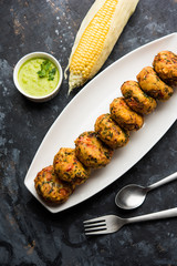 Crispy Corn Tikki, pakora/pakoda or pattice also known as cutlet. served with green chutney. Selective focus