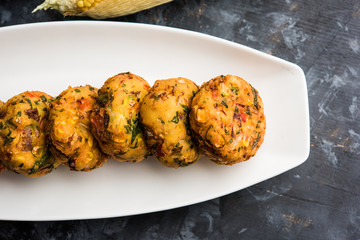 Crispy Corn Tikki, pakora/pakoda or pattice also known as cutlet. served with green chutney. Selective focus