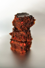 A stack of chocolate brownies isolated on white silver background, homemade bakery and dessert.