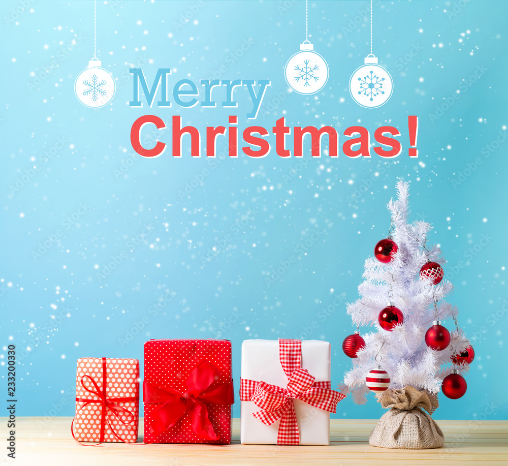 Wall mural Merry christmas message with a white Christmas tree and gift boxes - Wall murals