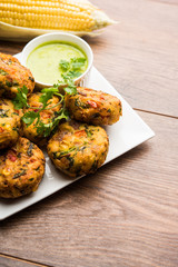 Crispy Corn Tikki, pakora/pakoda or pattice also known as cutlet. served with green chutney. Selective focus