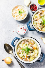 Sauerkraut red bean meat soup in pots. Top view, space for text.