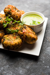 Crispy Corn Tikki, pakora/pakoda or pattice also known as cutlet. served with green chutney. Selective focus