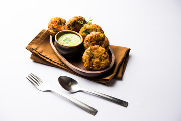 Crispy Corn Tikki, pakora/pakoda or pattice also known as cutlet. served with green chutney. Selective focus