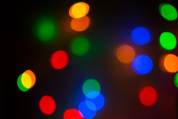 Multicolored glitter garland lights bokeh background, overlay. Bright holiday lights.